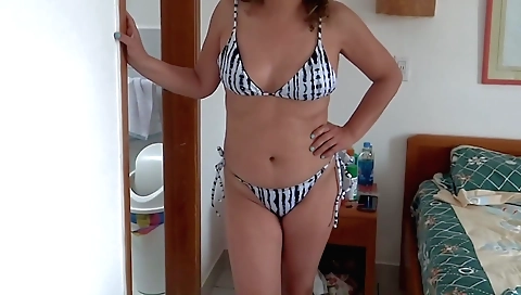 Sexy girl with a beautiful face and sexy body is out at the beach