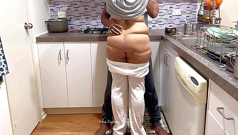 Indian chick is getting her hubby to fuck her in the kitchen